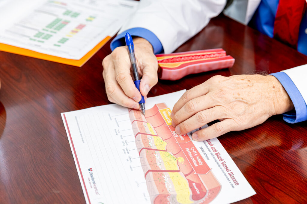 A medical provider uses a diagram of a blood vessel to explain advanced medical screening in Rocky Mount.