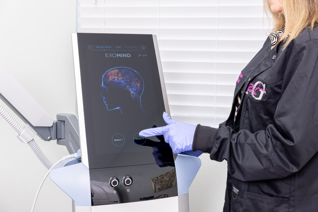 A provider at Amazing Grace Aesthetics makes a selection on the Exomind device screen to provide anxiety disorder treatments in Rocky Mount.